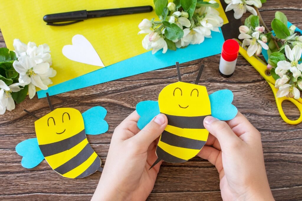 Mother's day greeting card gift - bee with spring apple tree flowers on a wooden table.