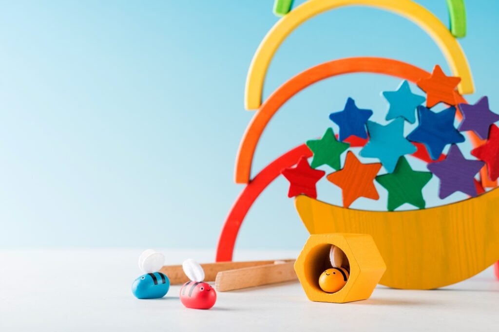 Wooden educational toys for preschool children on a blue background. Montessori method. Copy space.